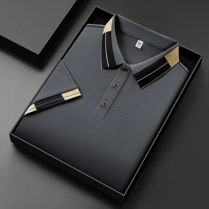 Folded dark gray polo shirt with black and beige striped collar and sleeve detail in black gift box