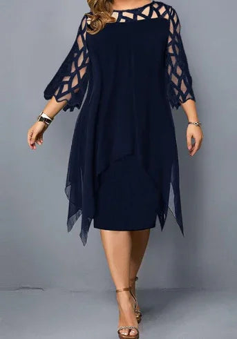 woman wearing elegant navy blue knee-length dress with sheer geometric lace sleeves and asymmetrical hem