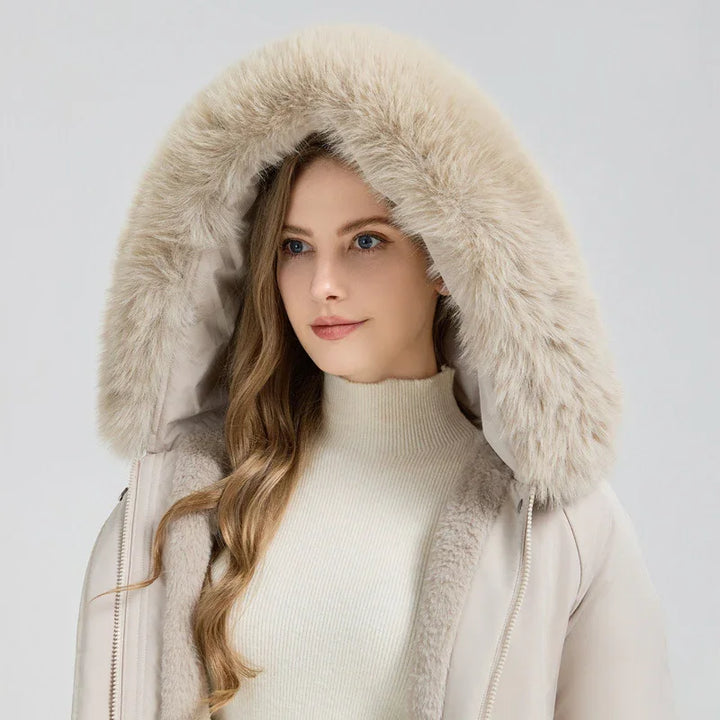 Woman wearing beige parka with large fur-lined hood and cream turtleneck sweater