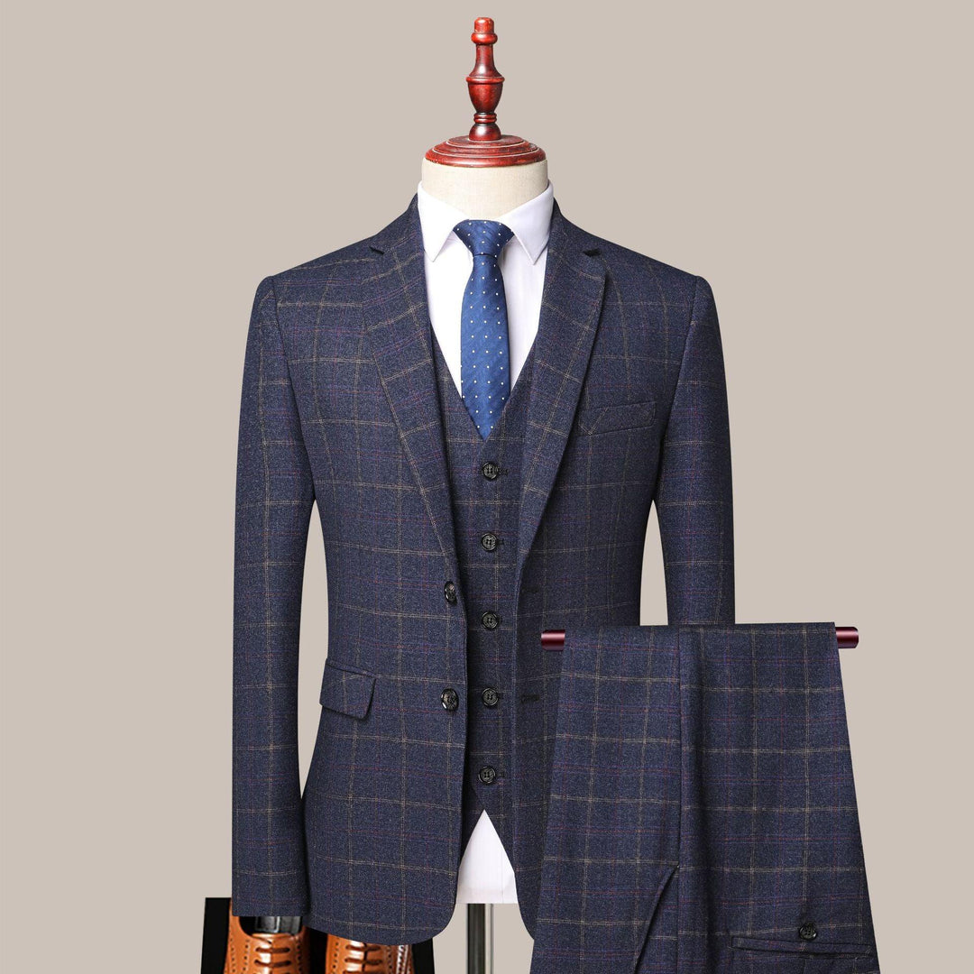Navy blue checked three-piece suit with white shirt and blue polka dot tie on mannequin