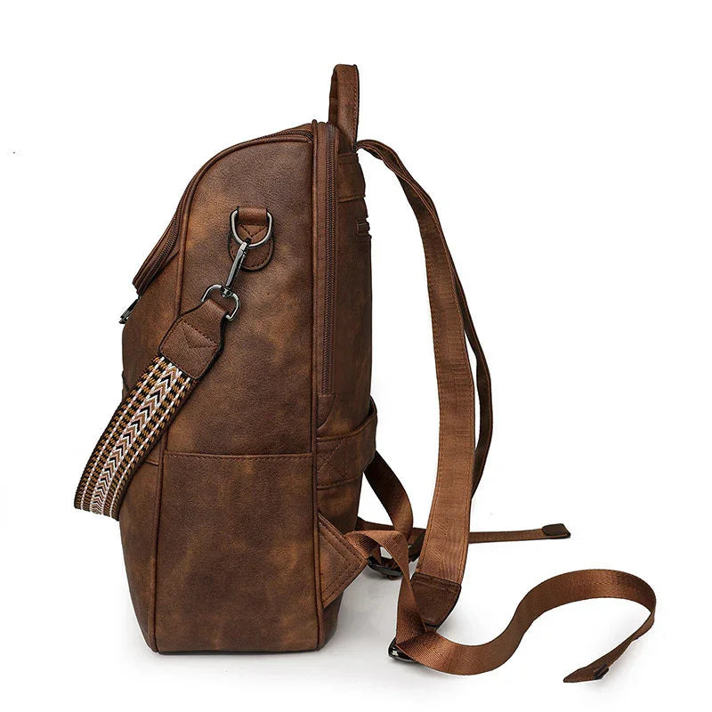 Side view of brown leather backpack with adjustable straps and patterned shoulder strap