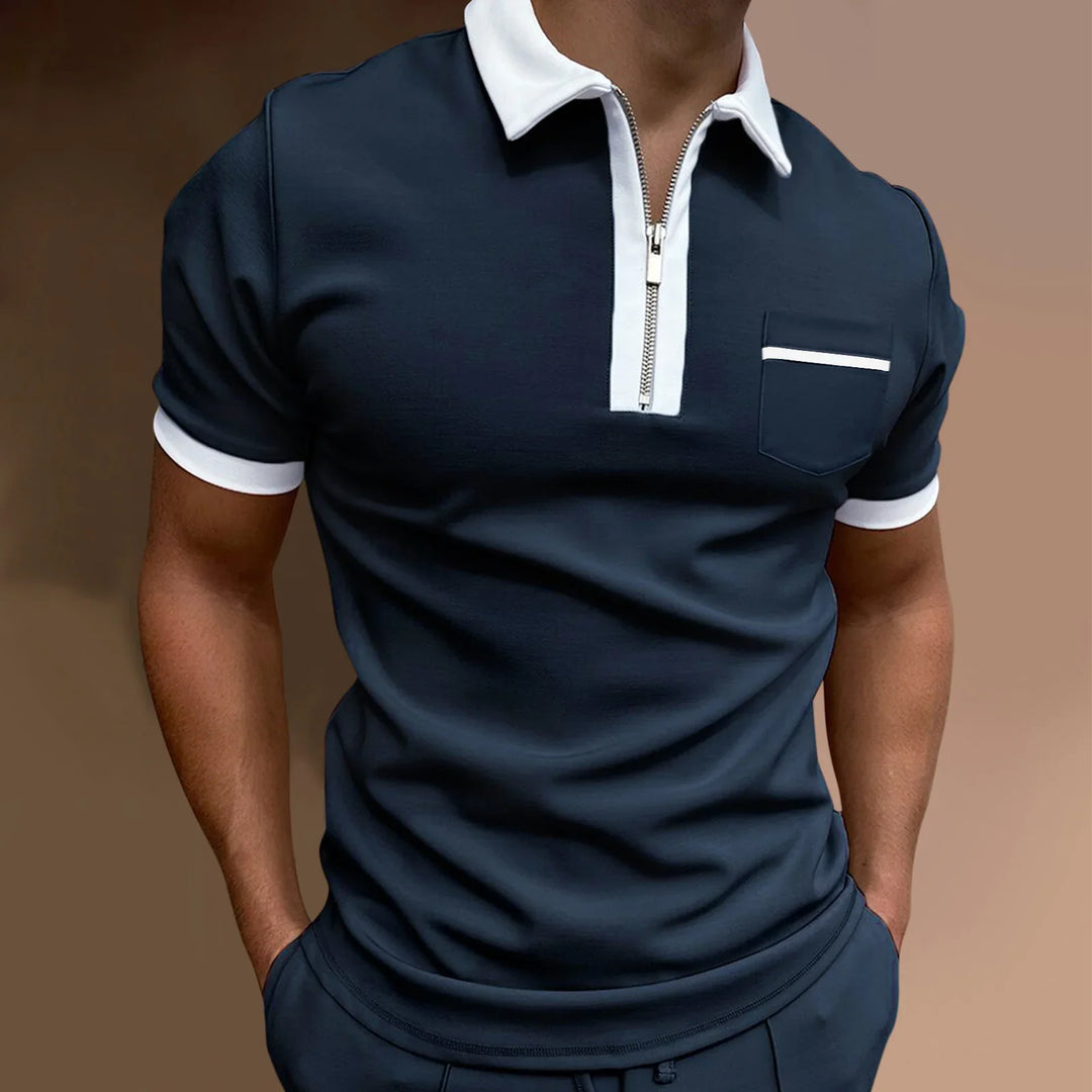 Men's navy blue polo shirt with white collar, zipper front, white sleeve cuffs, and chest pocket detail