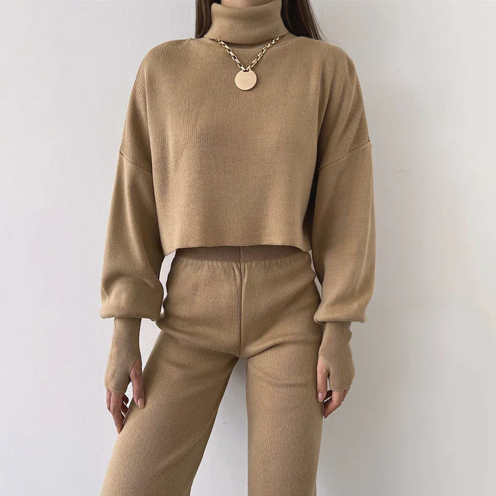 Woman wearing beige knit turtleneck sweater with thumb holes and matching knit pants outfit