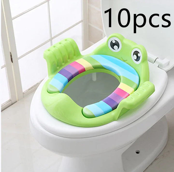 Green frog-shaped toddler potty training seat with colorful striped cushion on white toilet