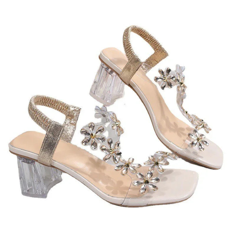Elegant women's clear-heeled sandals with gold ankle straps and flower-shaped crystal embellishments