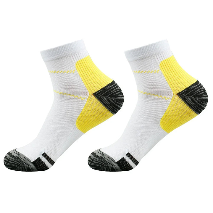 Pair of white athletic ankle socks with yellow heel padding and black toe reinforcement