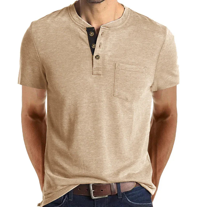 Beige short sleeve henley shirt with chest pocket and brown buttons, worn with jeans and brown belt