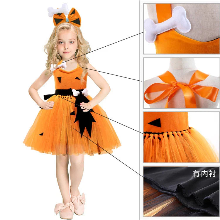 Girl wearing orange Halloween pumpkin dress with bone and black bow details and matching headband