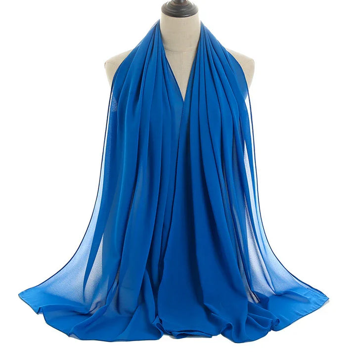 Soft blue chiffon scarf draped elegantly on mannequin against white background