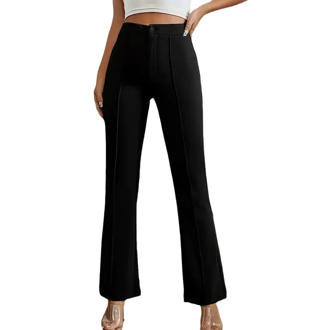 Woman wearing high-waisted black tailored pants with front seam detail and a white crop top