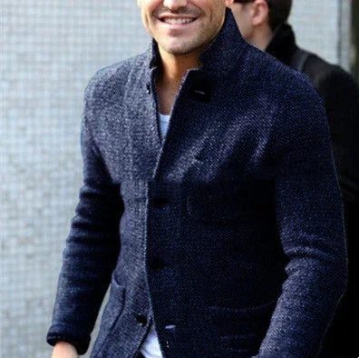 Man wearing stylish dark blue textured wool blazer over white shirt, casual urban look