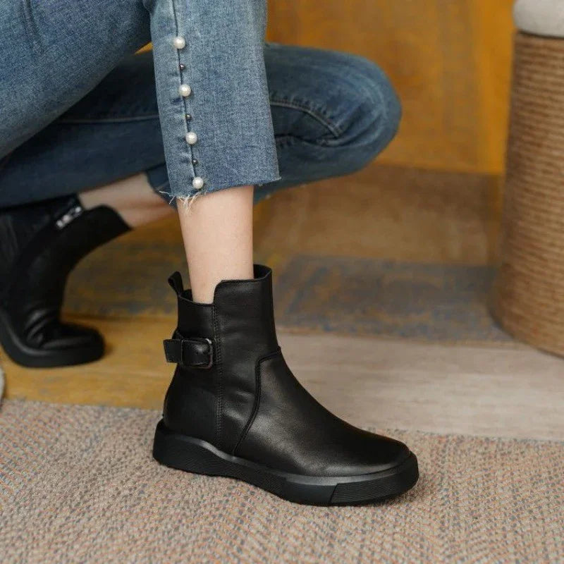 black leather ankle boots with buckle detail worn with cropped blue jeans featuring pearl buttons