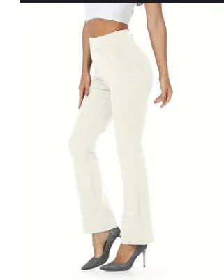 Woman wearing white flared pants and gray high heels, posing side view on white background