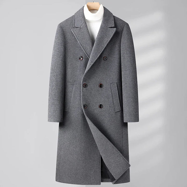 Men's gray double-breasted wool overcoat with notch lapels, hanging on wooden hanger