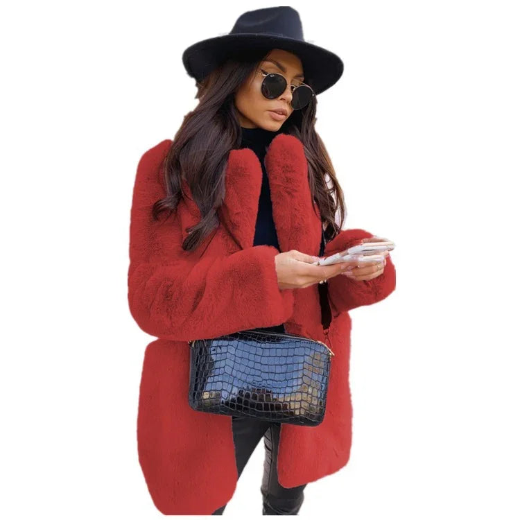 Woman wearing a red faux fur coat, black hat, sunglasses, holding smartphone and a black crocodile pattern handbag