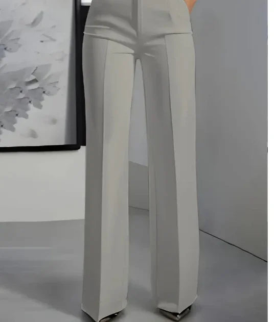Light gray high-waisted wide-leg trousers with front crease detail in minimalist modern setting