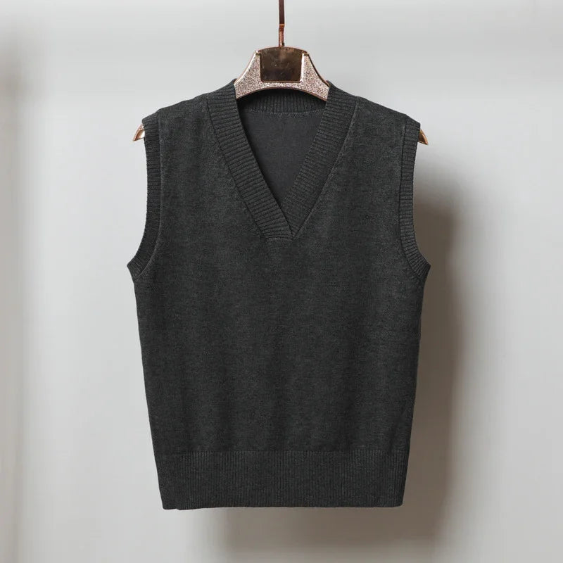 Dark gray sleeveless knitted sweater vest with V-neck on wooden hanger