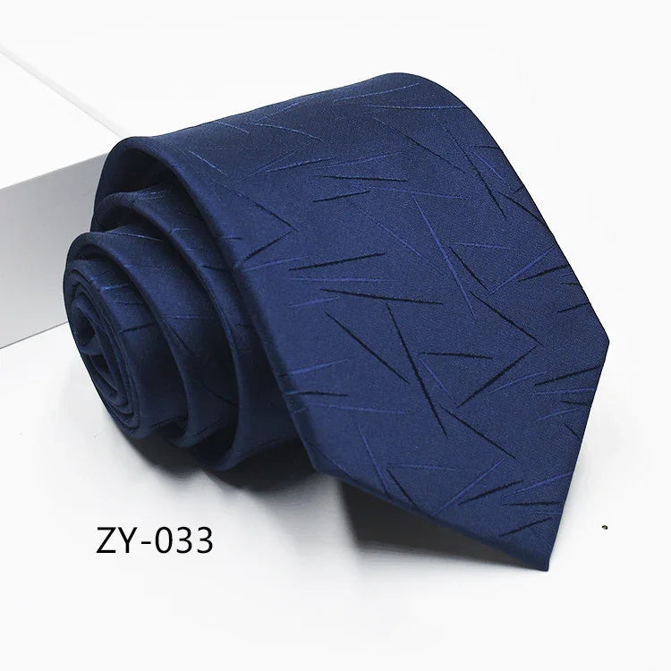 Navy blue men's tie with subtle geometric line pattern, rolled and displayed on white background