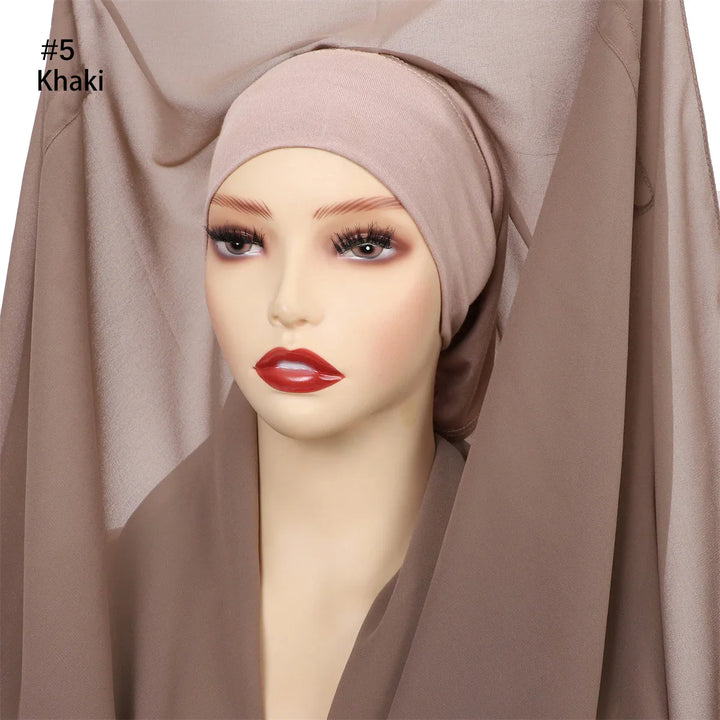 Mannequin head wearing khaki-colored inner hijab cap with matching chiffon fabric background