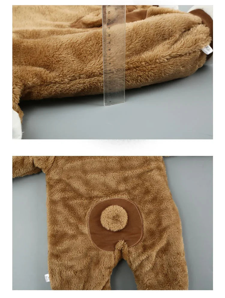 Close-up of soft brown plush baby romper with ruler for thickness measurement and bear tail detail on back