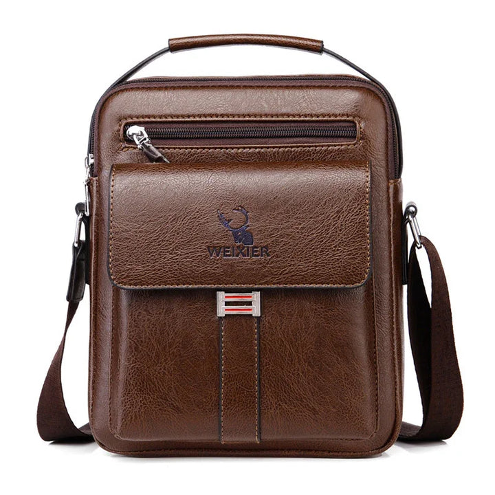 Brown leather Wexner men's crossbody bag with front pocket, zipper, and shoulder strap