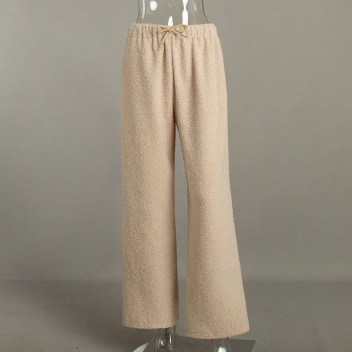 Beige fuzzy wide-leg lounge pants with drawstring waistband on transparent mannequin