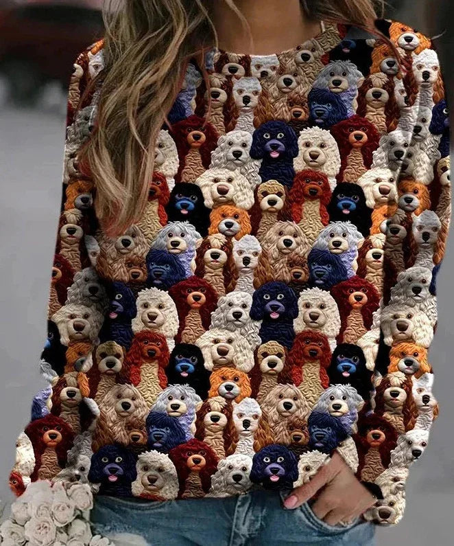 Woman wearing colorful sweatshirt with cartoon dog faces pattern in outdoor casual setting