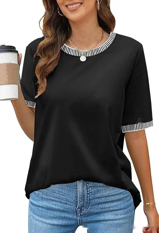 Woman wearing black short-sleeve t-shirt with white striped collar and cuffs, holding takeaway coffee cup