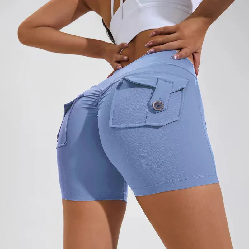 woman wearing light blue high-waisted shorts with buttoned back pockets and white crop top