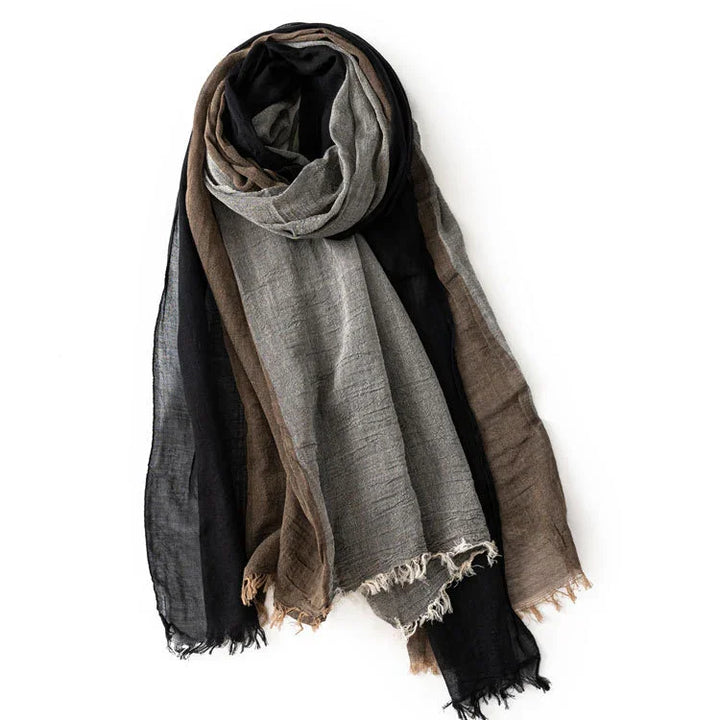 soft lightweight scarf in black, brown, and gray cotton with frayed edges on white background