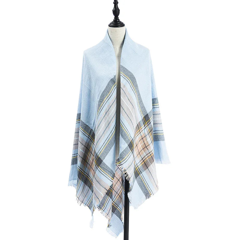 Light blue plaid shawl with beige and gray stripes draped on a dress form mannequin