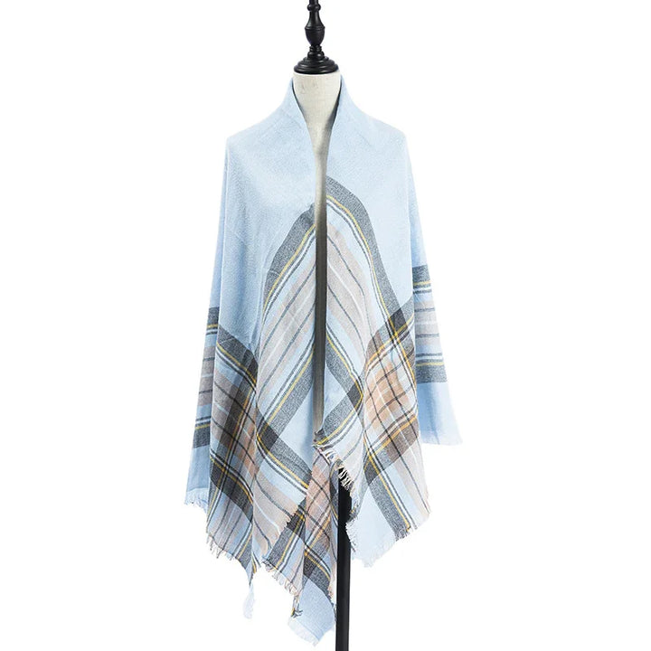 Light blue plaid shawl with beige and gray stripes draped on a dress form mannequin