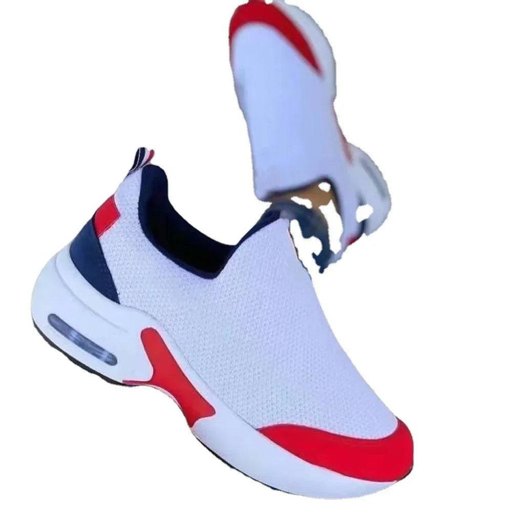 White slip-on athletic sneakers with red and black accents and air cushion sole