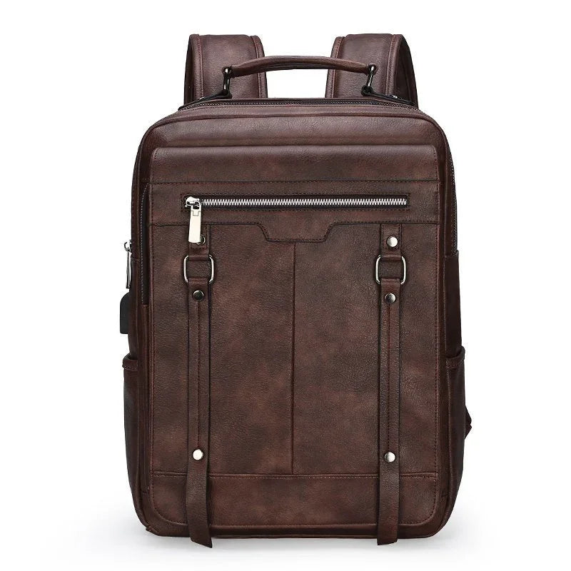 Brown leather backpack with front zipper pocket, dual buckle straps, and top handle against white background