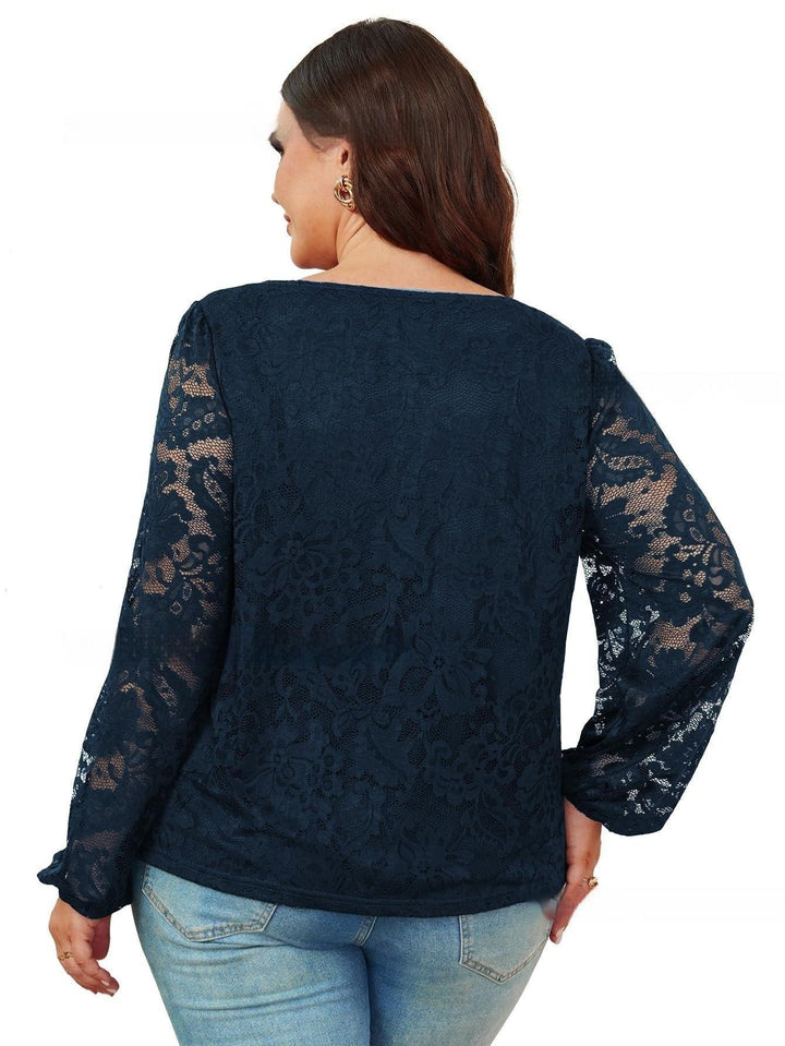 Plus size woman wearing navy blue floral lace long sleeve top with light blue jeans, back view