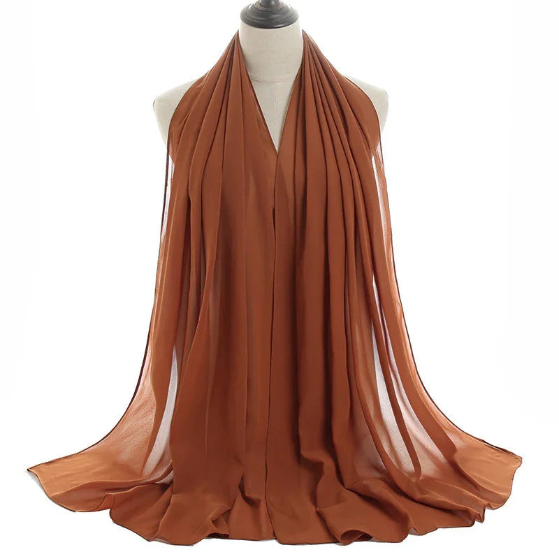 Brown lightweight chiffon scarf draped on white mannequin with soft flowing texture