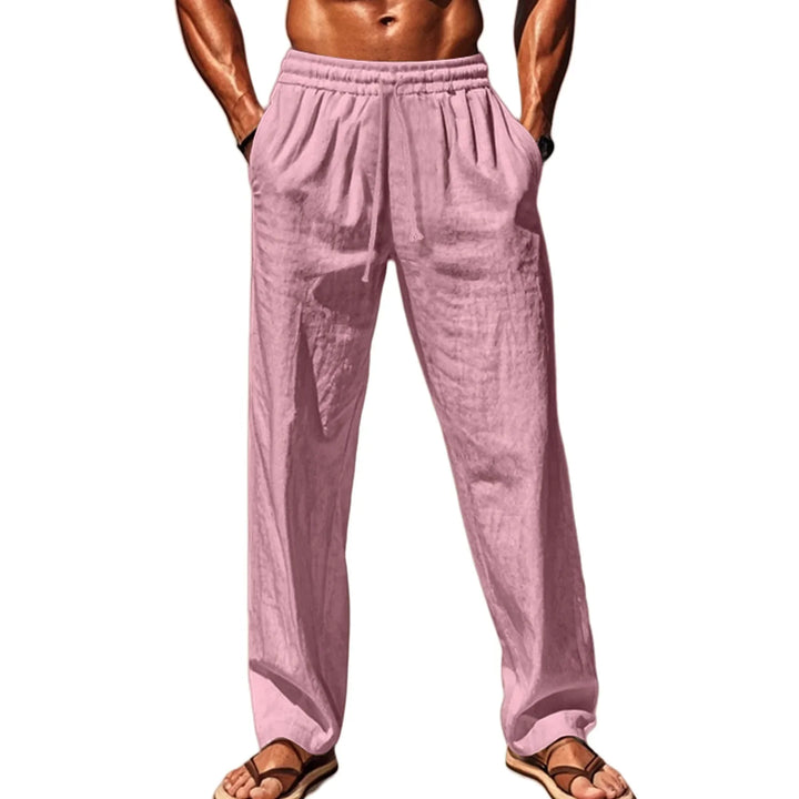 Male model wearing light pink casual linen pants with drawstring and pockets, paired with sandals