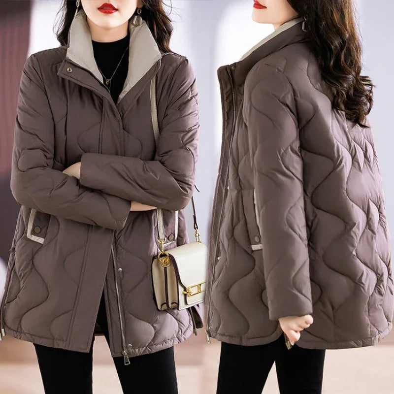 Woman wearing stylish brown quilted jacket with beige inner collar, carrying cream handbag