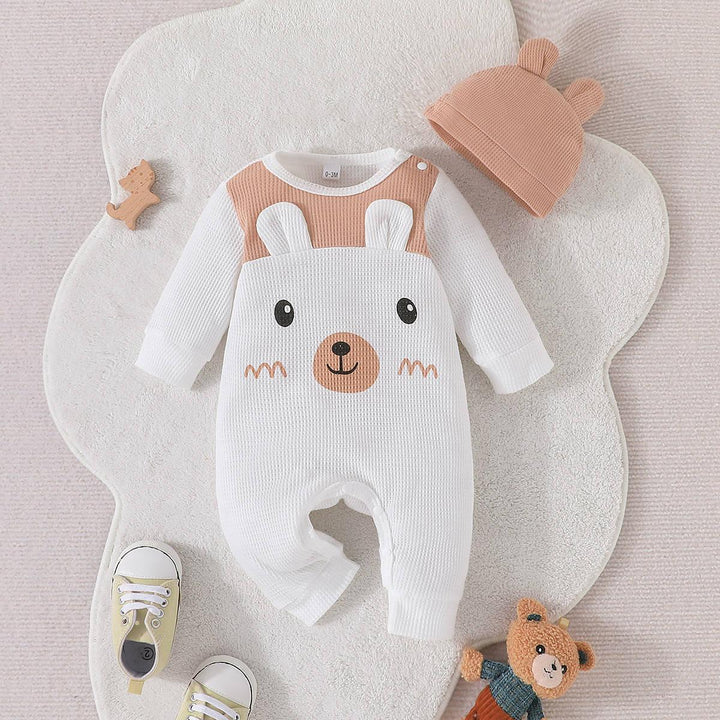 Cute baby onesie with bear face design, matching hat with bear ears, baby shoes, and teddy bear toy