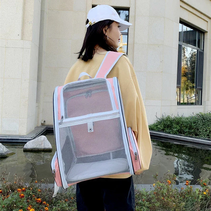 Woman wearing beige jacket and white cap with large transparent pink mesh backpack outdoors