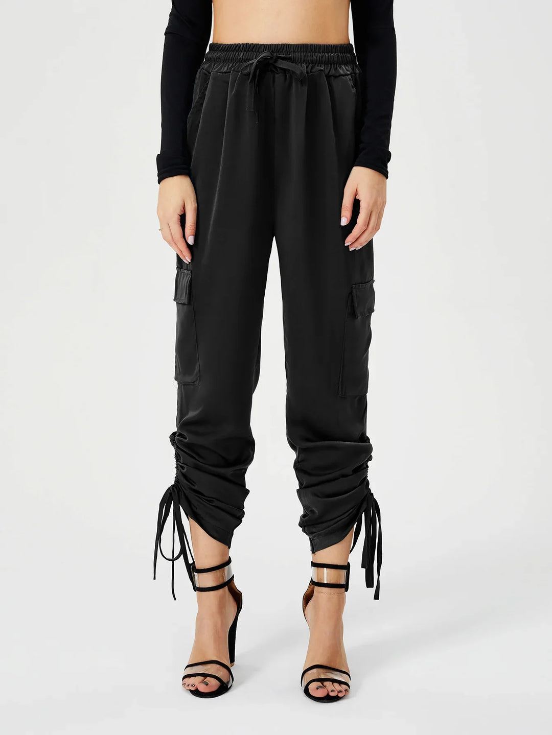 Black ruched cargo pants with drawstring detail paired with black strappy high heel sandals