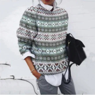 woman wearing green and white patterned knit sweater over white shirt, holding black handbag indoors