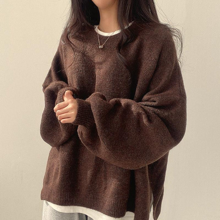 Woman wearing oversized brown wool sweater with long sleeves and white undershirt