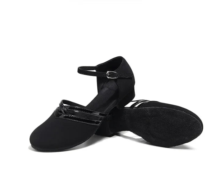 Black women's jazz dance shoes with ankle strap and soft sole on white background