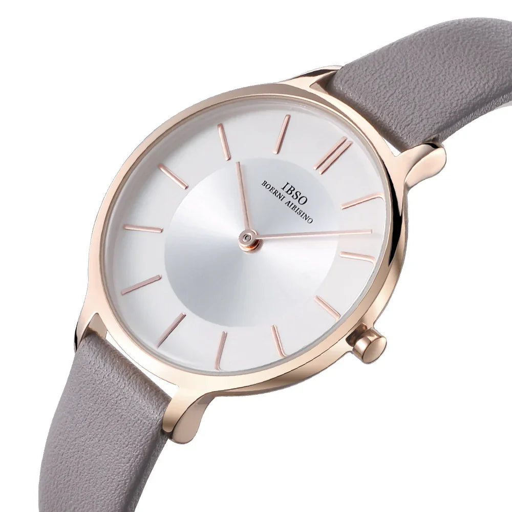 Minimalist IBSO wristwatch with rose gold case, white dial, and gray leather strap