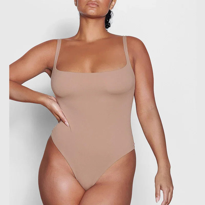 woman wearing nude seamless square neck bodysuit with high-cut legs on light background