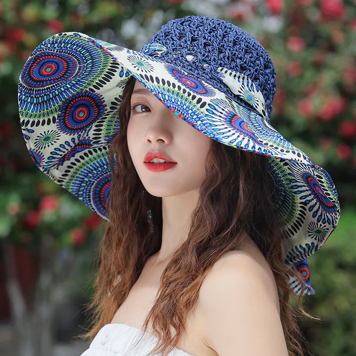 Young woman wearing colorful wide-brimmed summer hat with blue crochet top and patterned brim