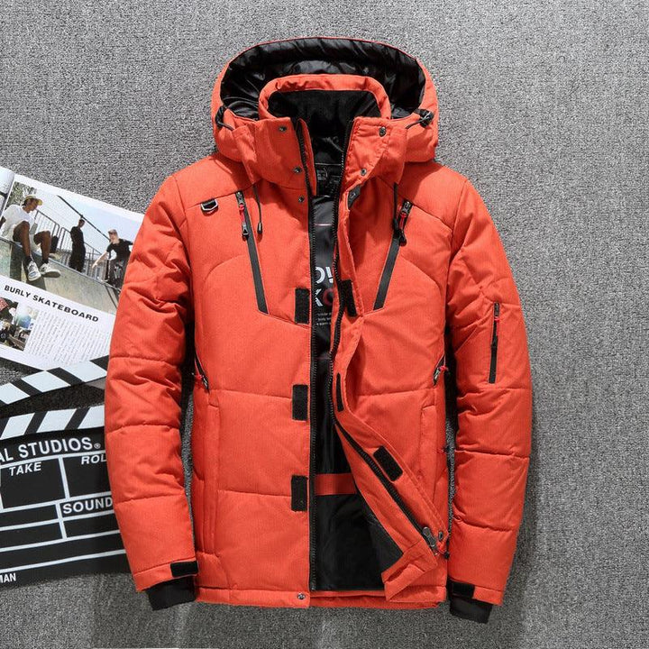 Orange insulated winter jacket with black interior lining, multiple zip pockets, and attached hood on gray background