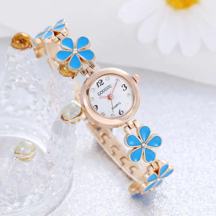 Rose gold wristwatch with blue flower accents and white dial marked GOUGOU quartz