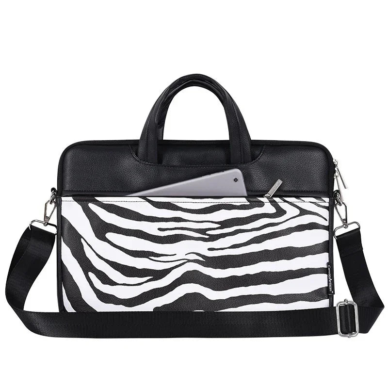 Black and white zebra print laptop bag with handles, adjustable shoulder strap, and tablet in front pocket